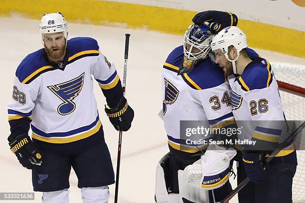 Paul Stastny and Kyle Brodziak celebrate with Jake Allen of the St. Louis Blues after their 6-3 win in game four over the San Jose Sharks in the...