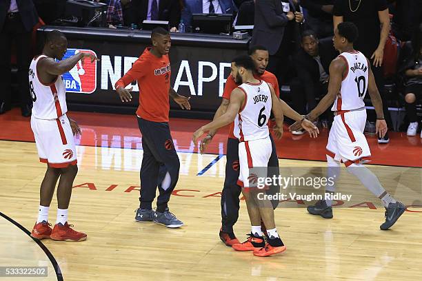 Norman Powell of the Toronto Raptors congratulates Cory Joseph after a made three-point basket during the second half against the Cleveland Cavaliers...
