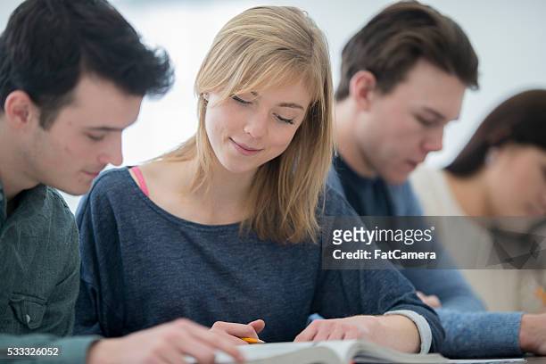 a multi-ethnic group of college age students are sittting - indian couple in theaters stock pictures, royalty-free photos & images