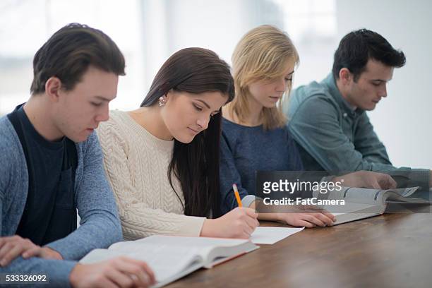 a multi-ethnic group of college age students are sittting - indian couple in theaters stock pictures, royalty-free photos & images