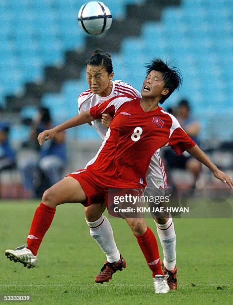 North Korean Jo Yun-Mi fights for the ball with Chinese Zhang Ying during their match of the East Asian Football Federation Women's Cup in Daegu...