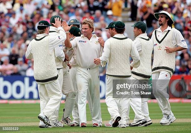 Shane Warne of Australia is congratulated by team mates after taking the wicket of Ashley Giles of England during day three of the Second npower...