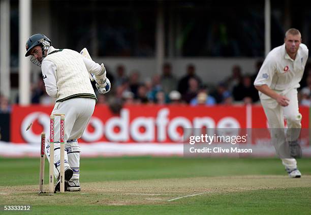 Andrew Flintoff of England takes the wicket of Justin Langer of Australia during day three of the second npower Ashes Test match between England and...