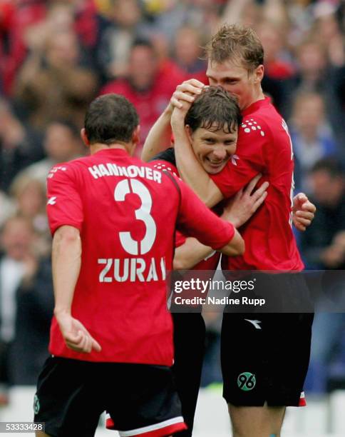 Dariusz Zuraw, Michael Tarnat and Per Mertesacker of Hanover celebrate Michael Tarnat scoring the the second and equalising goal during the...