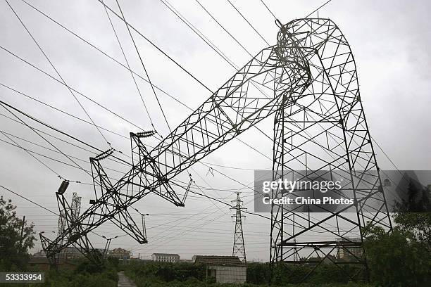 Fallen power transmission tower is seen in heavy wind following typhoon Matsa on August 6, 2005 in Ningbo of Zhejiang Province, southeast China....