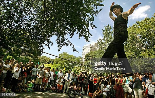 French aerialist Philippe Petit performs for a crowd in Washington Square Park August 6, 2005 in New York City. Petit walked on a tightrope between...