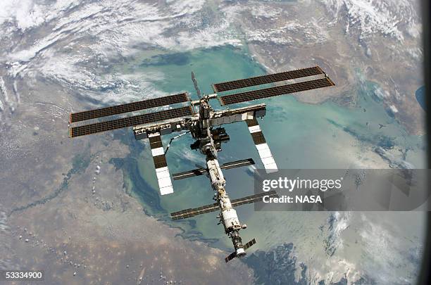 In this NASA handout, back dropped by Earth, the International Space Station is seen from the Space Shuttle Discovery following the undocking of the...