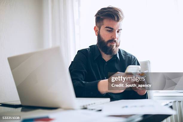 young man at the firm - business man smartphone tablet stock pictures, royalty-free photos & images