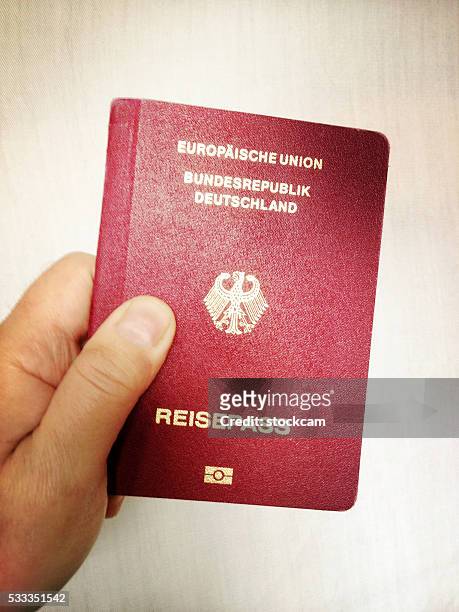 german passport reisepass close-up - german passports stock pictures, royalty-free photos & images