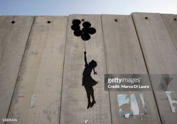 Graffiti titled "Balloon Debate" made by the British guerrilla, graffiti artist Banksy, is seen on August 6, 2005 on Israel's highly controversial...