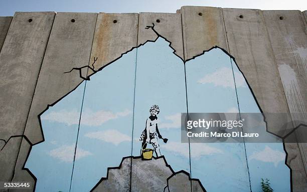 Graffiti titled "Art Attack" made by the British, guerrilla, graffiti artist Banksy is seen on Israel's highly controversial West Bank barrier in...