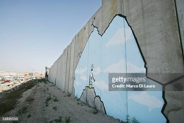 Graffiti titled "Art Attack" made by the British, guerrilla, graffiti artist Banksy is seen on Israel's highly controversial West Bank barrier in...