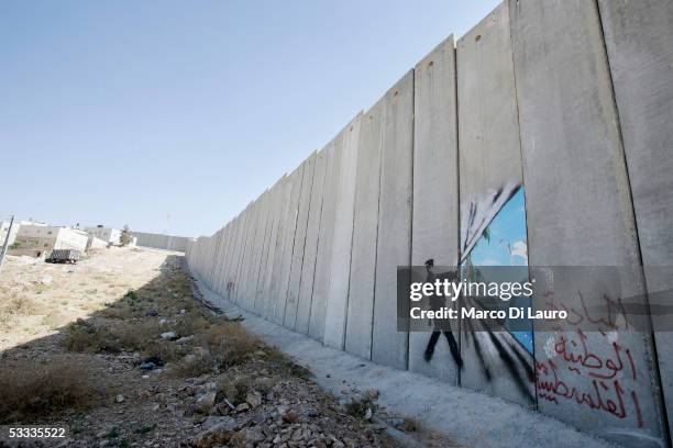 Graffiti made by the graffiti artist Banksy is seen on Israel's highly controversial West Bank barrier in Abu Dis on August 6, 2005. Banksy has made...