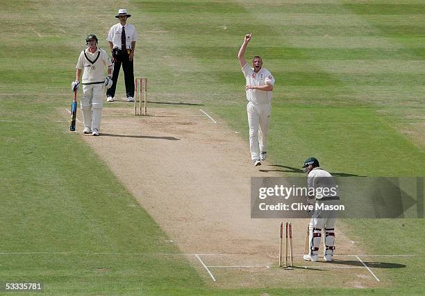 Andrew Flintoff of England celebrates taking the wicket of Shane Warne of Australia during day four of the second npower Ashes Test match between...