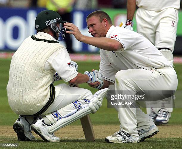 Birmingham, UNITED KINGDOM: Englands Andrew Flintoff consoles Australian Brett Lee after England beat Australia by just two runs to win the Second...