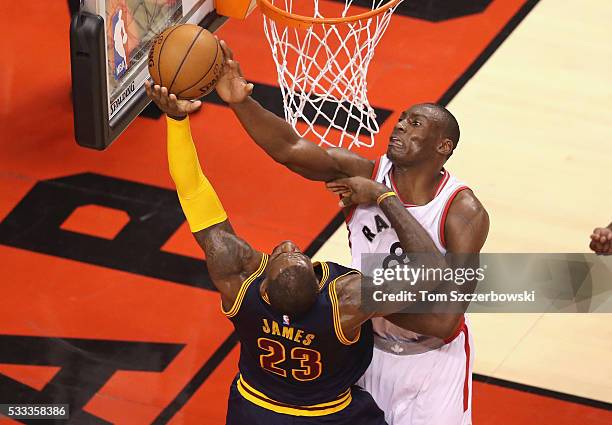 Bismack Biyombo of the Toronto Raptors blocks a shot by LeBron James of the Cleveland Cavaliers and is called for a foul during the second half in...