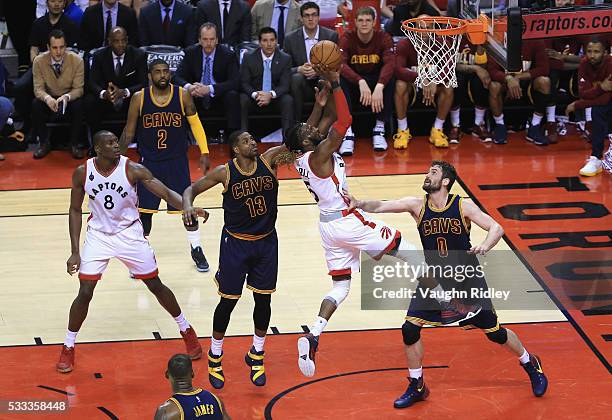 DeMarre Carroll of the Toronto Raptors shoots the ball against Tristan Thompson of the Cleveland Cavaliers and Kevin Love during the second half in...