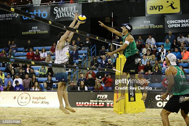 Gustavo Carvalhaes of Brazil hits the ball over the net against Josh Binstock of Canada during their Gold medal match during day 5 of the 2016 AVP...