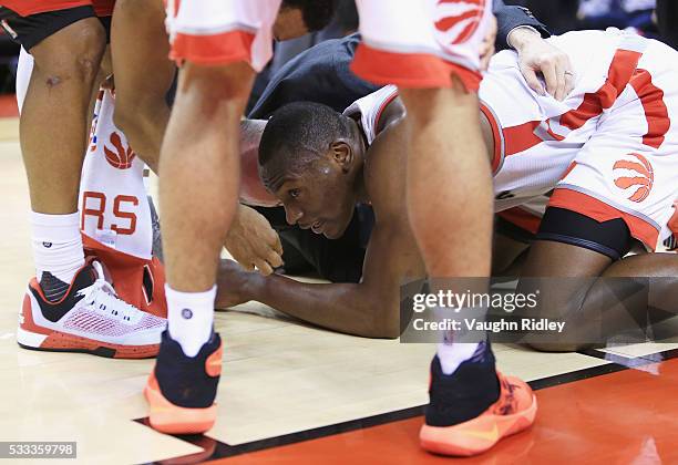 Bismack Biyombo of the Toronto Raptors reacts on the floor after the 4th quarter against the Cleveland Cavaliers in game three of the Eastern...