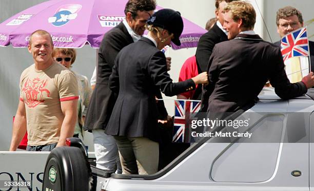 Mike Tindall, England and Gloucester rugby player watches as his girlfriend Zara Phillips, daughter of Princess Anne drives past with her team mates...