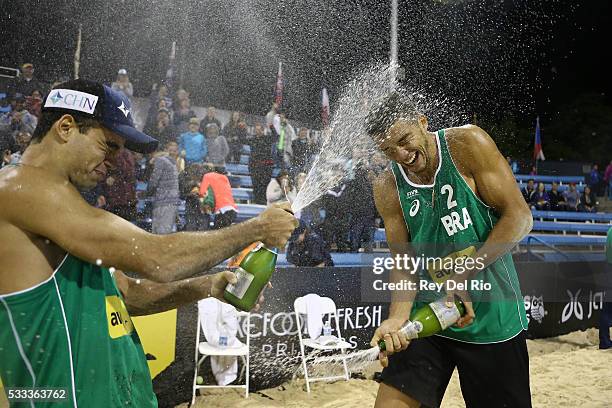 Gustavo Carvalhaes and Saymon Barbosa of Brazil celebrate after defeating Josh Binstock and Sam Schachter of Canada in the Gold medal match during...