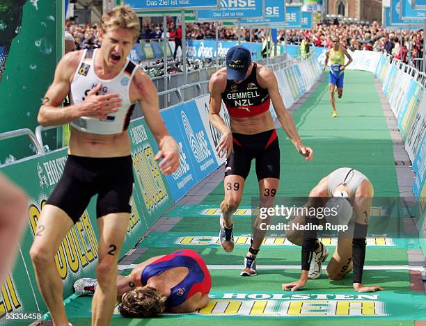 Exhausted athletes arrive at the finish during the Holsten City Man Elite Triathlon on August 7, 2005 in Hamburg, Germany.