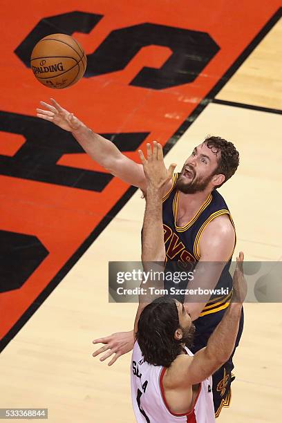 Kevin Love of the Cleveland Cavaliers shoots the ball against Luis Scola of the Toronto Raptors during the second half in game three of the Eastern...