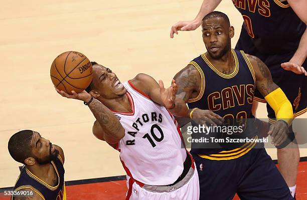DeMar DeRozan of the Toronto Raptors shoots the ball as LeBron James of the Cleveland Cavaliers reacts during the second half in game three of the...