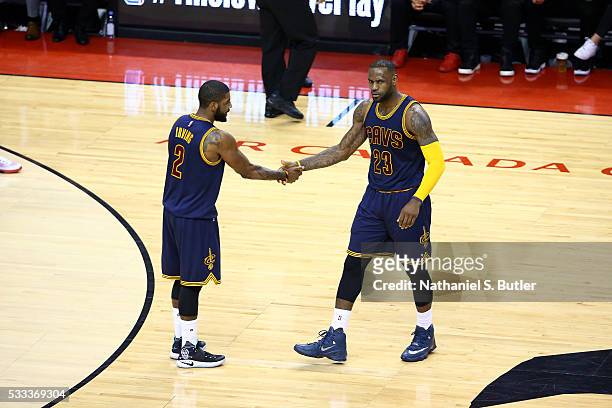 LeBron James and Kyrie Irving of the Cleveland Cavaliers high five each other during the game against the Toronto Raptors in Game Three of the...