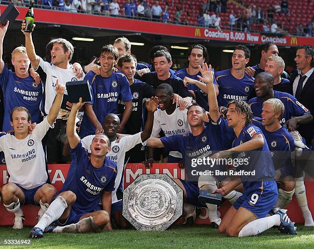 Chelsea players celebrate with the trophy following the FA Community Shield match between Arsenal and Chelsea held at the Millennium Stadium on...