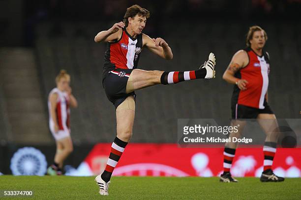 Former Saints star Justin Koschitzke kicks the ball in a Legends game before the round nine AFL match between the St Kilda Saints and the Essendon...