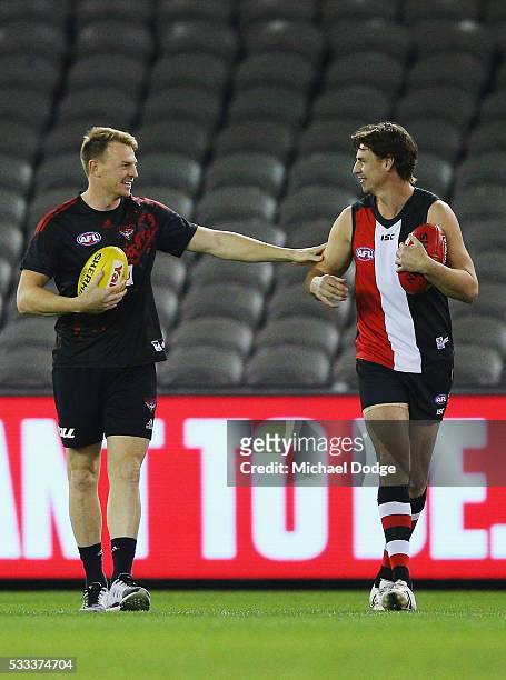 Brendon Goddard of the Bombers catches up woth former teammate Justin Koschitzke who played in a Legends game before the round nine AFL match between...