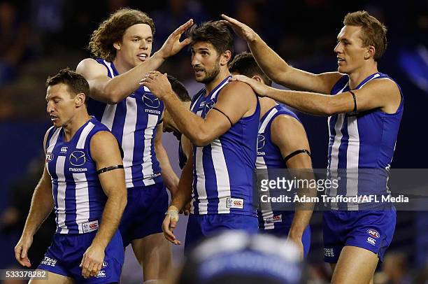 Jarrad Waite of the Kangaroos is congratulated by teammates Ben Brown and Drew Petrie of the Kangaroos during the 2016 AFL Round 09 match between the...