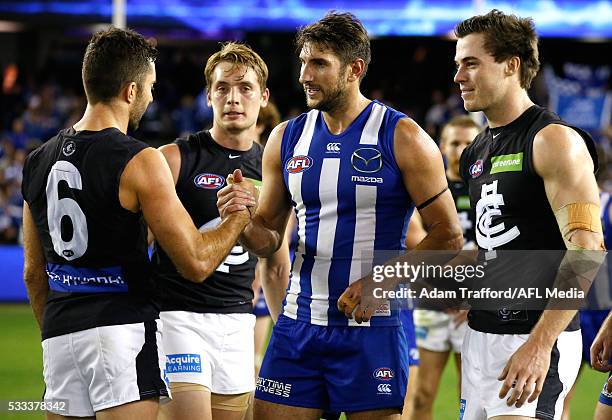 Jarrad Waite of the Kangaroos shakes hands with former teammate Kade Simpson of the Blues during the 2016 AFL Round 09 match between the North...