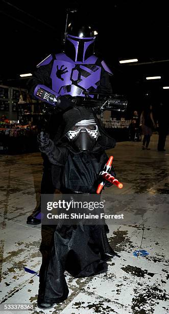 Young cosplayer dressed as Kylo Ren of Star Wars The Force Awakens and his father in a customised Boba Fett costume attend Film & Comic Con...