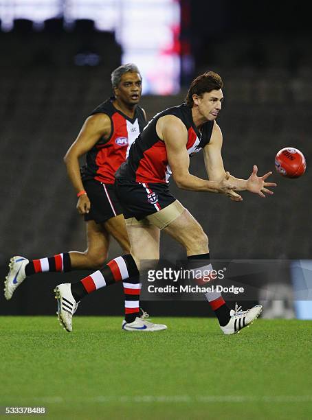 Former Saints star Justin Koschitzke marks the ball in a Legends game before the round nine AFL match between the St Kilda Saints and the Essendon...