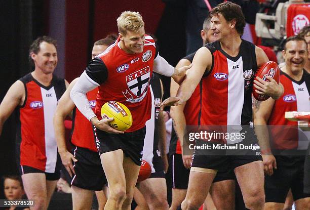 Former Saints star Justin Koschitzke is greeted by former teammate Nick Riewoldt of the Saints as he walks out for a Legends game before the round...