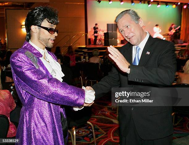 Prince impersonator Jason Tenner of Nevada greets President George W. Bush impersonator John Morgan of Florida during the opening night of the...