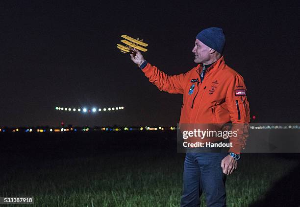 In this handout image supplied by SI2, Bertrand Piccard, welcoming Solar Impulse 2 , piloted by Swiss adventurer Andre Borschberg at Dayton...