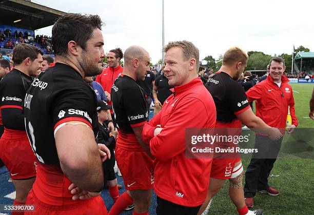 Brad Barritt captain of Saracens chats to director of rugby Mark McCall after their victory during the Aviva Premiership semi final match between...