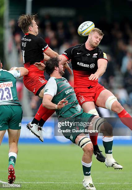Dom Barrow of Leicester is beaten to the high ball by Chris Wyles and Geroge Kruis during the Aviva Premiership semi final match between Saracens and...