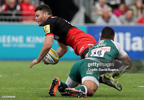 Duncan Taylor of Saracens is tackled by Telusa Veainu during the Aviva Premiership semi final match between Saracens and Leicester Tigers at Allianz...