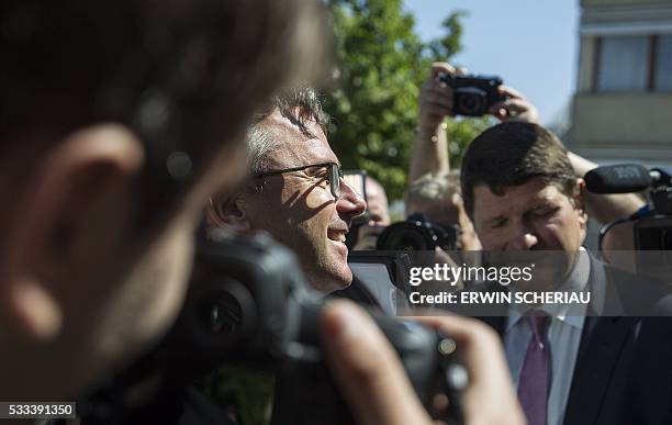 Austrian Freedom Party candidate Norbert Hofer is surrounded by journalists after he dropped his ballot during the second round of Austrian President...