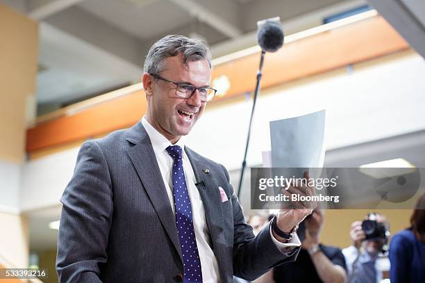 Norbert Hofer, member of Austria's Freedom party and presidential candidate, reacts as he receives his ballot at a voting station in Pinkafeld,...