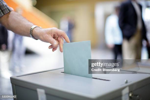 Voter casts his vote into a ballot box in Pinkafeld, Austria, on Sunday, May 22, 2016. Austrian voters go to the polls Sunday to elect a new...