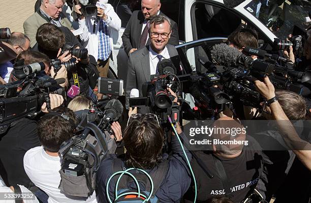 Norbert Hofer, member of Austria's Freedom party and presidential candidate, is surrounded by members of the media at a voting station in Pinkafeld,...