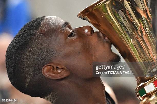 Juventus' midfielder from France Paul Pogba kisses the trophy after winning the Italian Tim Cup final football match AC Milan vs Juventus on May 21,...