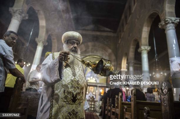 Bishop Daniel, the deputy of Egyptian Coptic Christian religious leader Pope Tawadros II, leads a mourning ceremony attended by relatives and friends...