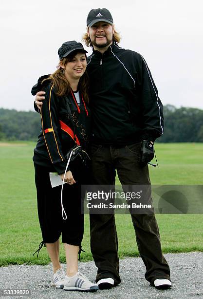 Garvey Rea, singer of the band Reamon, poses with his pregnant wife Josephine during the Adidas Golf Tournament at the golf club Herzogenaurach...