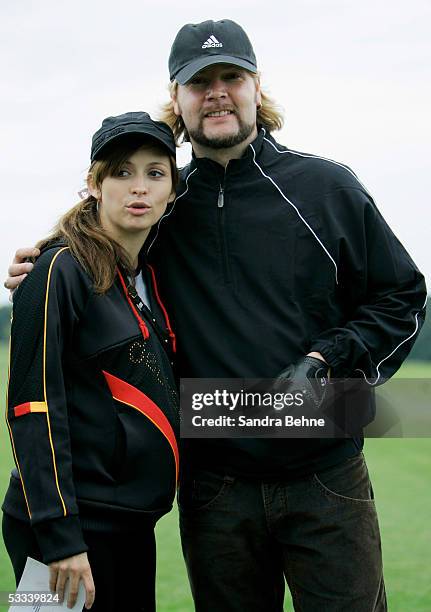 Garvey Rea, singer of the band Reamon, poses with his pregnant wife Josephine during the Adidas Golf Tournament at the golf club Herzogenaurach...